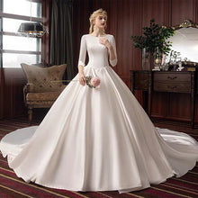 Load image into Gallery viewer, The Pristine Wedding Bridal Satin Long Sleeves Gown - WeddingConfetti
